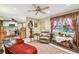 Bright living room with comfy seating, ceiling fan, and view into the kitchen at 1100 27Th W Ave, Palmetto, FL 34221