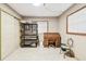 Home office with wooden desk and storage shelving at 1100 27Th W Ave, Palmetto, FL 34221