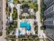 Aerial view of a resort-style community with pool, lush landscaping, and multiple buildings at 1211 Gulf Of Mexico Dr # 403, Longboat Key, FL 34228