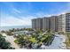 Oceanfront community with pool, lush landscaping, and a high-rise building at 1211 Gulf Of Mexico Dr # 403, Longboat Key, FL 34228