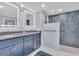 Updated bathroom features a double vanity and a stunning blue tile shower at 1211 Gulf Of Mexico Dr # 403, Longboat Key, FL 34228