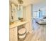 Stylish bathroom vanity with a large mirror and a comfortable stool at 1211 Gulf Of Mexico Dr # 403, Longboat Key, FL 34228