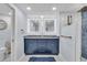 Elegant bathroom with double vanity, blue cabinets, and a walk-in shower at 1211 Gulf Of Mexico Dr # 403, Longboat Key, FL 34228