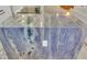 Island kitchen features stunning blue quartz countertops and modern appliances at 1211 Gulf Of Mexico Dr # 403, Longboat Key, FL 34228