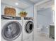 Convenient laundry room with washer and dryer, and additional storage at 1211 Gulf Of Mexico Dr # 403, Longboat Key, FL 34228