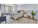 Large bedroom with ocean view, plush bedding, and ceiling fan at 1211 Gulf Of Mexico Dr # 403, Longboat Key, FL 34228