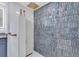 Large walk-in shower with blue hexagonal tile and white subway tile at 1211 Gulf Of Mexico Dr # 403, Longboat Key, FL 34228