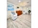 Casual sitting area with two armchairs and wood storage cabinet at 1211 Gulf Of Mexico Dr # 403, Longboat Key, FL 34228