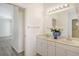 Double vanity bathroom with marble countertop and view into bedroom at 1447 Allegheny Ln, North Port, FL 34286