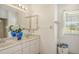 Double vanity bathroom with marble counters and a large mirror at 1447 Allegheny Ln, North Port, FL 34286