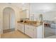 Bright kitchen features white cabinets, granite counters, and stainless steel appliances at 1447 Allegheny Ln, North Port, FL 34286