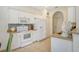 White kitchen with light countertops and tile backsplash at 1447 Allegheny Ln, North Port, FL 34286
