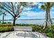 Peaceful lakeside view with a relaxing bench at 1447 Allegheny Ln, North Port, FL 34286