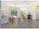 Bright living room featuring wood-look floors and view of pool at 1447 Allegheny Ln, North Port, FL 34286