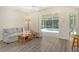 Living room with gray sofa and sliding doors to the pool area at 1447 Allegheny Ln, North Port, FL 34286