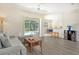 Spacious living room with gray sofa and pool view at 1447 Allegheny Ln, North Port, FL 34286