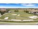 Aerial view showing golf course, sand traps and players at 17607 Gawthrop Dr # 103, Bradenton, FL 34211