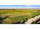 Aerial view of golf course driving range with many golfers at 17607 Gawthrop Dr # 103, Bradenton, FL 34211