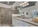 Modern bathroom with a walk-in shower and granite countertop at 17607 Gawthrop Dr # 103, Bradenton, FL 34211