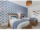 Bedroom with twin beds and blue patterned wallpaper at 17607 Gawthrop Dr # 103, Bradenton, FL 34211