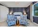 Serene bedroom with upholstered bed and stylish armchairs at 17607 Gawthrop Dr # 103, Bradenton, FL 34211