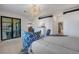 Elegant bedroom with balcony access and a view of the kitchen at 17607 Gawthrop Dr # 103, Bradenton, FL 34211