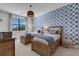Bedroom with twin beds and blue patterned wallpaper at 17607 Gawthrop Dr # 103, Bradenton, FL 34211
