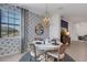 Charming dining room with floral wallpaper and a round dining table at 17607 Gawthrop Dr # 103, Bradenton, FL 34211
