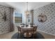 Dining area with round table and chairs and decorative wallpaper at 17607 Gawthrop Dr # 103, Bradenton, FL 34211