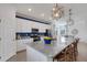 Island kitchen features white cabinets, granite counters & blue accent wall at 17607 Gawthrop Dr # 103, Bradenton, FL 34211