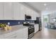 Bright kitchen with white cabinets, stainless steel appliances, and granite counters at 17607 Gawthrop Dr # 103, Bradenton, FL 34211