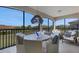 Screened lanai with outdoor dining set and scenic view at 17607 Gawthrop Dr # 103, Bradenton, FL 34211