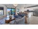 Open concept living room and kitchen with blue sofa and island at 17607 Gawthrop Dr # 103, Bradenton, FL 34211