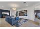 Relaxing living room featuring blue sofa and built-in media cabinet at 17607 Gawthrop Dr # 103, Bradenton, FL 34211
