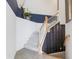 A carpeted staircase with a wooden handrail and decorative wall at 17607 Gawthrop Dr # 103, Bradenton, FL 34211
