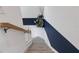 Elegant staircase with a modern color scheme and patterned wall at 17607 Gawthrop Dr # 103, Bradenton, FL 34211