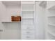 Large walk-in closet with shelves and drawers at 17607 Gawthrop Dr # 103, Bradenton, FL 34211