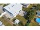 Aerial view showcasing a home's exterior, backyard patio, pool, and shed at 1790 Ezelle Ave, Largo, FL 33770