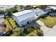 Aerial view of a two-story house with metal roof, driveway, and landscaped yard at 1790 Ezelle Ave, Largo, FL 33770