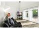 Bright living room with hardwood floors, sliding glass doors, and comfy seating at 1790 Ezelle Ave, Largo, FL 33770