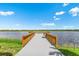Peaceful waterfront dock with seating overlooking a lake at 17920 Palmiste Dr, Bradenton, FL 34202