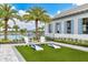 Relaxing lawn area with cornhole and comfortable seating at 17920 Palmiste Dr, Bradenton, FL 34202
