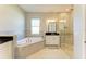 Elegant bathroom with soaking tub, walk-in shower, and modern vanity at 1810 5Th E St, Palmetto, FL 34221