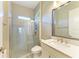 Clean bathroom with a walk-in shower, quartz vanity, and stylish mirror at 1810 5Th E St, Palmetto, FL 34221