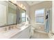 Clean bathroom with double vanity, white cabinets and subway tile at 1810 5Th E St, Palmetto, FL 34221