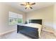 Spacious bedroom with ceiling fan, window blinds, and a comfortable bed at 1810 5Th E St, Palmetto, FL 34221