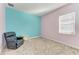 Relaxing bedroom with accent wall and comfortable recliner at 1810 5Th E St, Palmetto, FL 34221