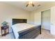 Bright bedroom with ceiling fan, walk-in closet, and a queen-size bed at 1810 5Th E St, Palmetto, FL 34221