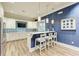 Modern community kitchen with white cabinets, blue backsplash and breakfast bar at 1810 5Th E St, Palmetto, FL 34221