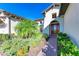 Front entry with brick walkway, lush landscaping, and arched doorway at 1810 5Th E St, Palmetto, FL 34221
